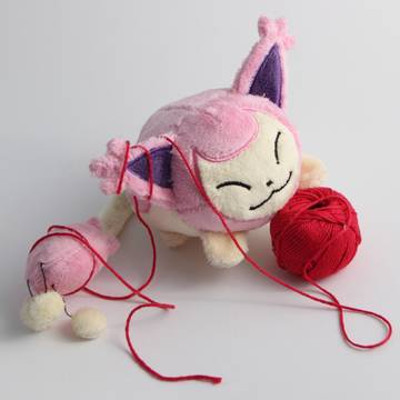Skitty playing with ball of yarn