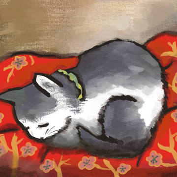 布団で寝る猫
